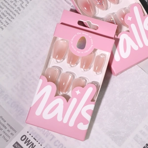Short trapezoid press-on nails in nude cat-eye glitter finish with pink gradient packaging
