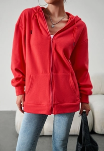 Close-up of red fleece hooded jacket with full zipper and functional front pockets