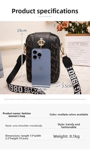Close-up of mini floral phone bag with crown ornament and patterned 1980 CITY wide strap