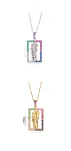 Flat lay of square Virgin Mary pendants in gold and silver with colorful zircons
