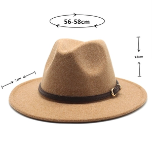 Detail showing camel wool fedora hat with thin brown leather band and gold buckle detail