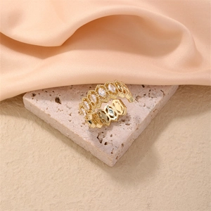 Detail of adjustable gold ring with marquise-cut white zircons and openwork texture