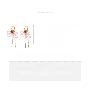 Detailed close-up of handmade floral bow earrings with glass beads and resin charms