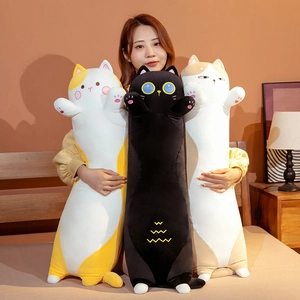 Detailed embroidery and soft plush fabric of long cat body pillows in cozy home setting