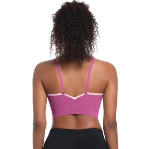 Close-up of pink sports bra featuring cross straps and V-shaped open back detail