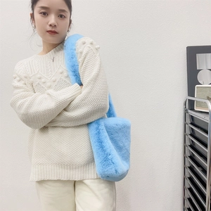 Blue faux fur tote bag styled with white sweater showing size and plush texture