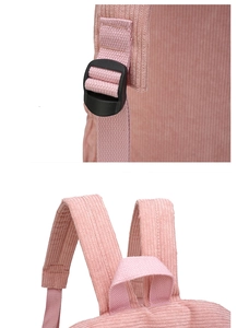 Detailed macro view of pink corduroy backpack featuring plastic buckle and handle