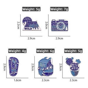 Detailed view of outdoor enamel pins showing weights and dimensions for hiking themes