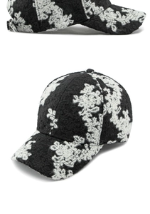 Detail view of monochrome floral jacquard texture on structured winter baseball cap