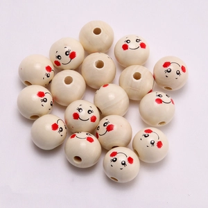 Macro detail of 20mm wooden beads with cute printed smiley faces for DIY jewelry making