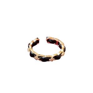 Gold plated open ring featuring black leather chain weave and sparkling zircon accents