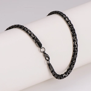 Minimalist black stainless steel box chain necklace with lobster clasp on white stand