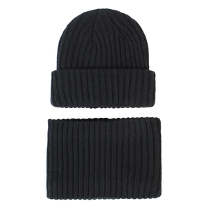 Detail of black rib-knit winter set showing beanie hat and matching neck warmer texture
