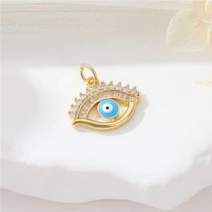 Golden Evil Eye pendant with blue enamel and sparkling cubic zirconia crystals