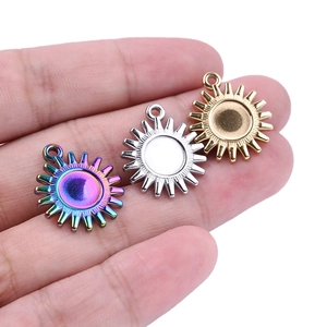 Macro shot of 304 stainless steel sun charms in rainbow, silver, and gold finishes