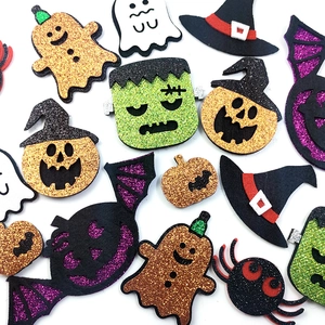 Flat lay of glitter and felt Halloween decorative patches including pumpkins and ghosts