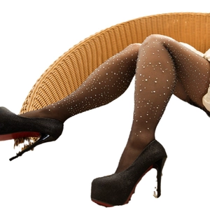 Black sheer pantyhose with sparkling rhinestones paired with high heels on a woven chair