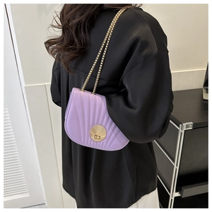 Detailed view of a purple shell-shaped PU leather crossbody bag with golden chain strap