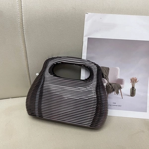 Translucent dark brown acrylic handbag with horizontal textured wave pattern for evening use