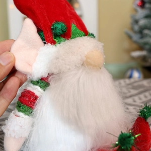 Macro detail of Christmas gnome with sequin red hat and long white beard decoration