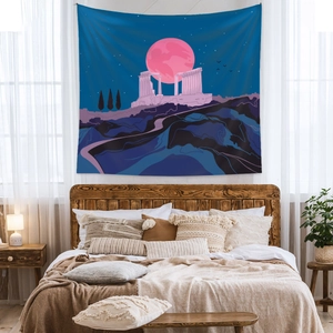 Bohemian wall tapestry with pink full moon and ancient temple ruins in a cozy bedroom decor