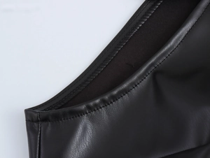 Close-up detail of black faux leather texture and fine stitching on a biker style maxi dress