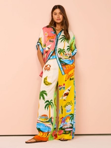 Detail of colorful printed casual two-piece set featuring wide leg trousers and shirt