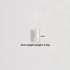 Macro detail of 9x3mm gold-plated S925 silver charm with white zircon micro-paving