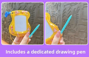 Detail view of yellow magnetic drawing board toy with attached stylus and cute stickers