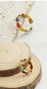 Detail of colorful enamel smiley face open ring with golden stainless steel band