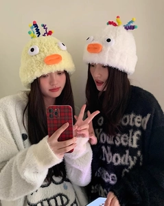 Detail of cute knitted bird hats featuring colorful spring antennas and plush warmth