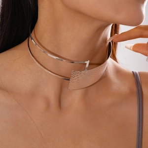 Detail of silver double-layered choker with a textured hammered metal plate finish