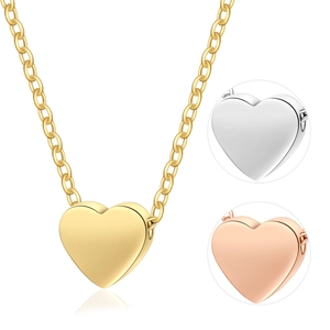 Golden heart locket necklace with celestial star moon charms and polished finish