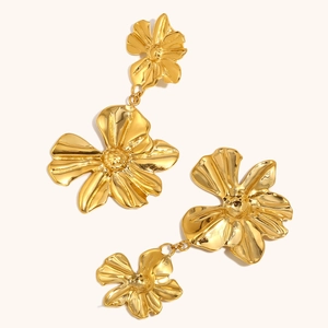 Detailed macro view of 18K gold plated stainless steel double flower dangle earrings