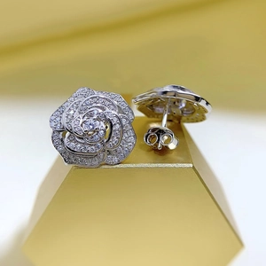 Macro detail of silver rose stud earrings with micro-paved cubic zirconia crystals