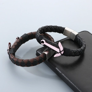 Detail of woven leather anchor bracelets with colorful charms and magnetic metal clasps