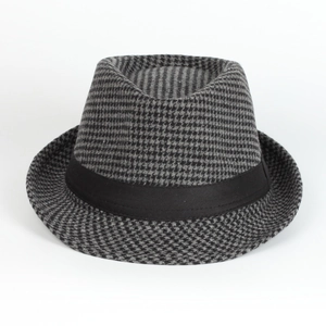 Detail of houndstooth jazz fedora hat featuring a black grosgrain ribbon on white background
