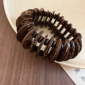 Close-up of vintage brown coconut shell beads on ethnic style beaded bracelet