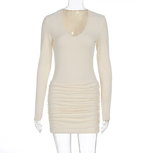 Detail view of the elegant ruched texture and slim fit design on a beige V-neck dress