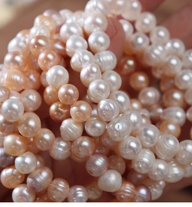 Close-up of natural freshwater pearls showing multicolored luster and authentic textures