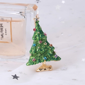 Detail of Christmas tree brooch with green glitter enamel and colorful rhinestones