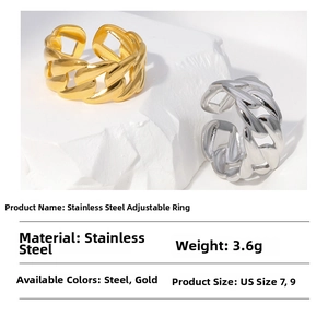 Detail showing two adjustable cuban chain rings in gold and steel on a white stone
