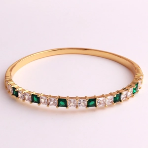 Detail of 18K gold-plated hinged bracelet with emerald-cut cubic zirconia in prong setting