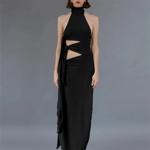 Detail of waist cutout and lace-up strap design on black backless maxi dress