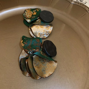 Detail of vintage floral fabric earrings with green brocade and gold embroidery