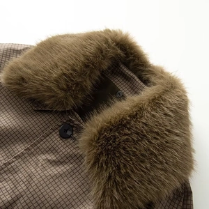 Close-up of brown plaid fabric and thick faux fur collar on the reversible trench coat