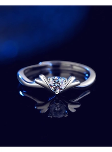 Macro shot of a V-shaped sterling silver ring with a sparkling round-cut moissanite stone
