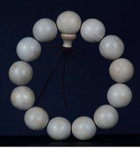 Macro shot of natural wood grain texture on high-quality camphor wood prayer beads