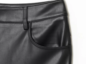 Close-up of black leather pants showing fine stitching and side pocket detail