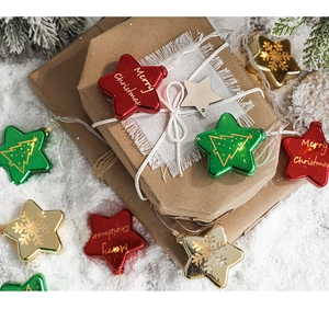 Close-up of colorful Christmas star LED lights with festive snowflake patterns and pine decor